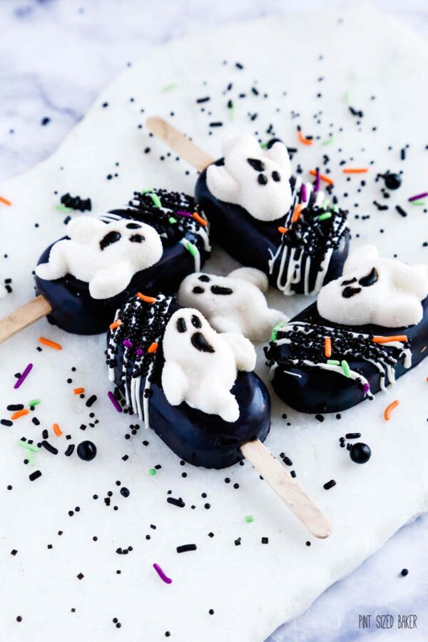 White ghost candies on black cakesickles with black sprinkles.