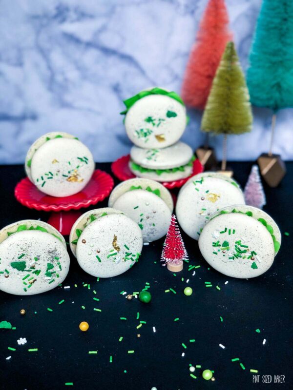 The Macarons standing up with mini Christmas trees in the background.