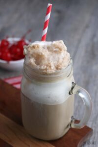 A close up of the finished hard root beer float in a mug with a straw, ready to be enjoyed.
