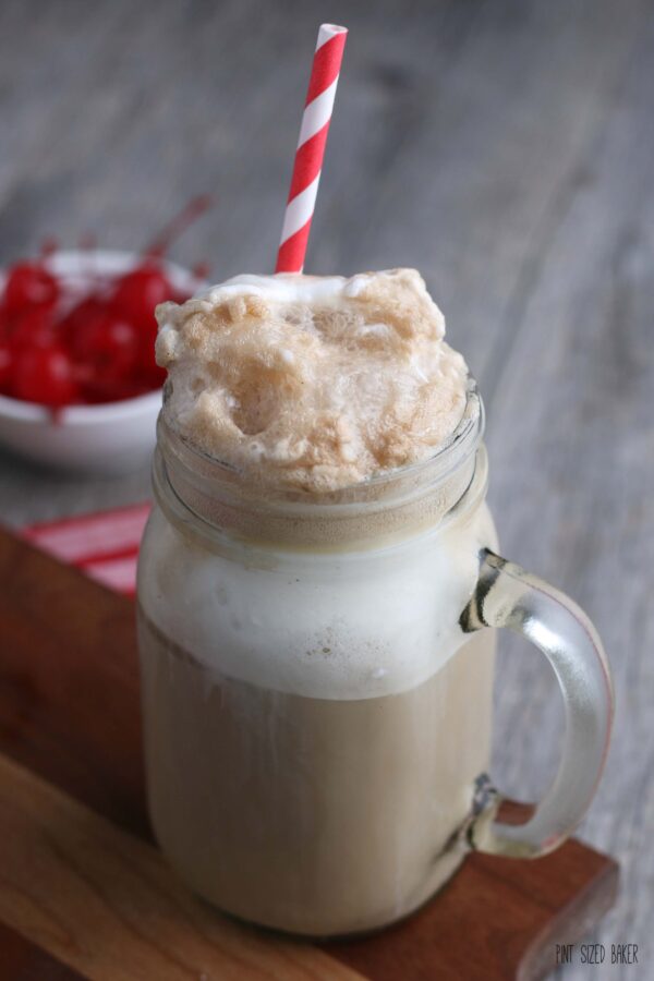 A close up of the finished hard root beer float in a mug with a straw, ready to be enjoyed. 