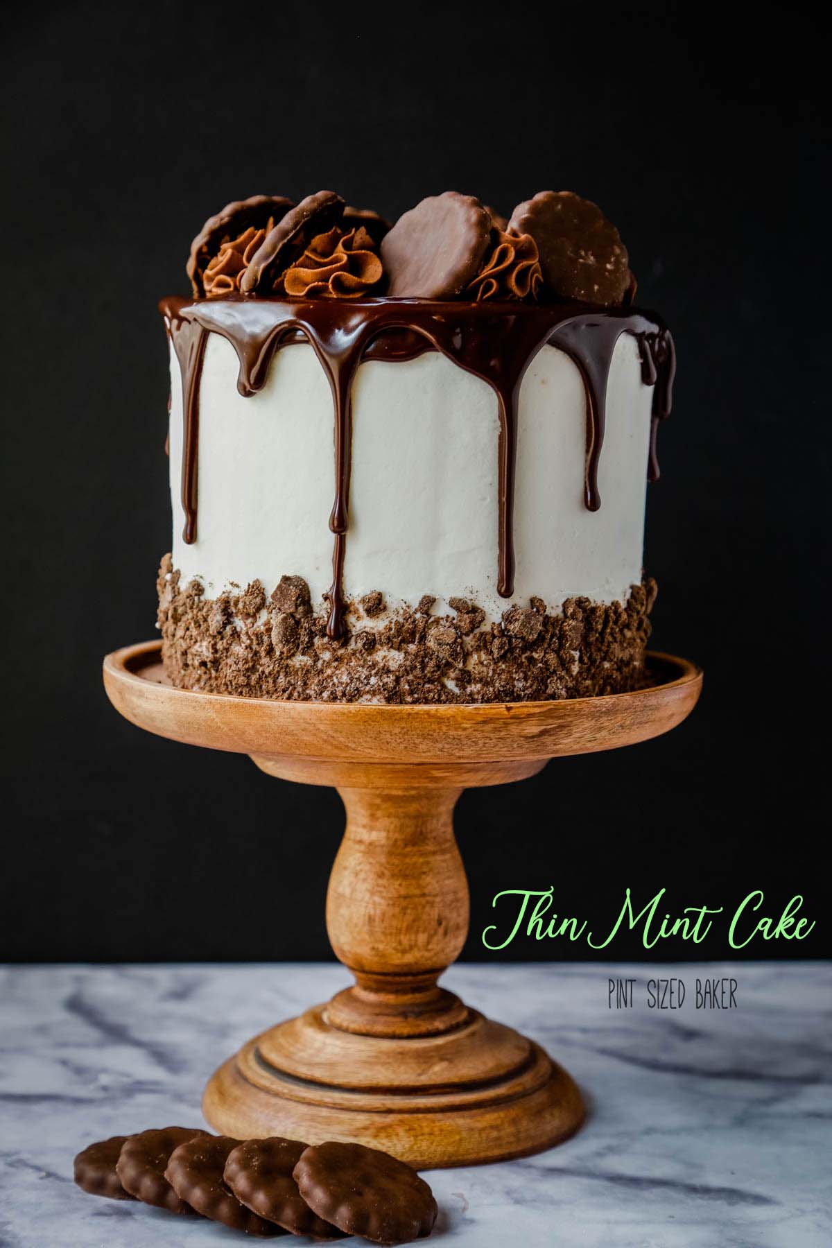 A Thin Mint Cookie Cake on a wooden cake pedestal.