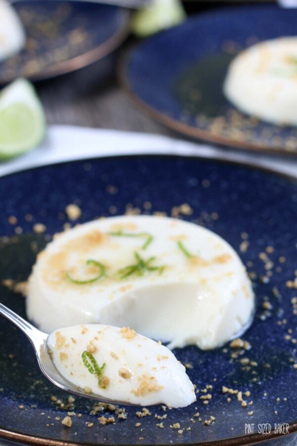 One of the servings of key lime panna cotta with a spoonful out and ready to be devoured. 