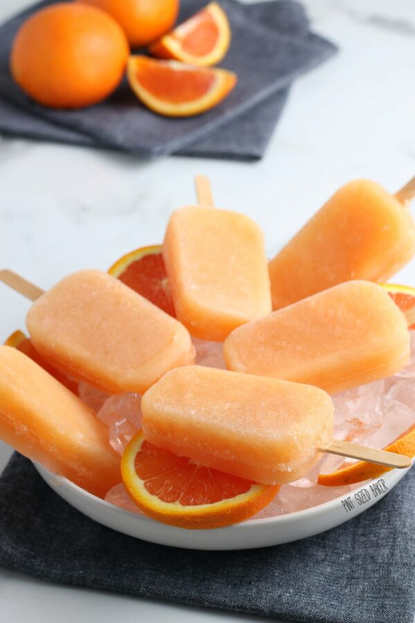 An image of the Orange Juice Popsicles in a white bowl.