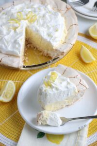 Here we see a slice of the finished lemon meringue pie on a plate with a bite taken out of it.