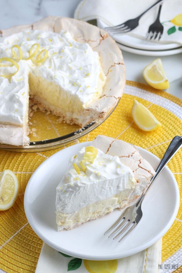 A view of the slice of upside down lemon meringue pie with the rest of the pie in the background ready to be shared. 