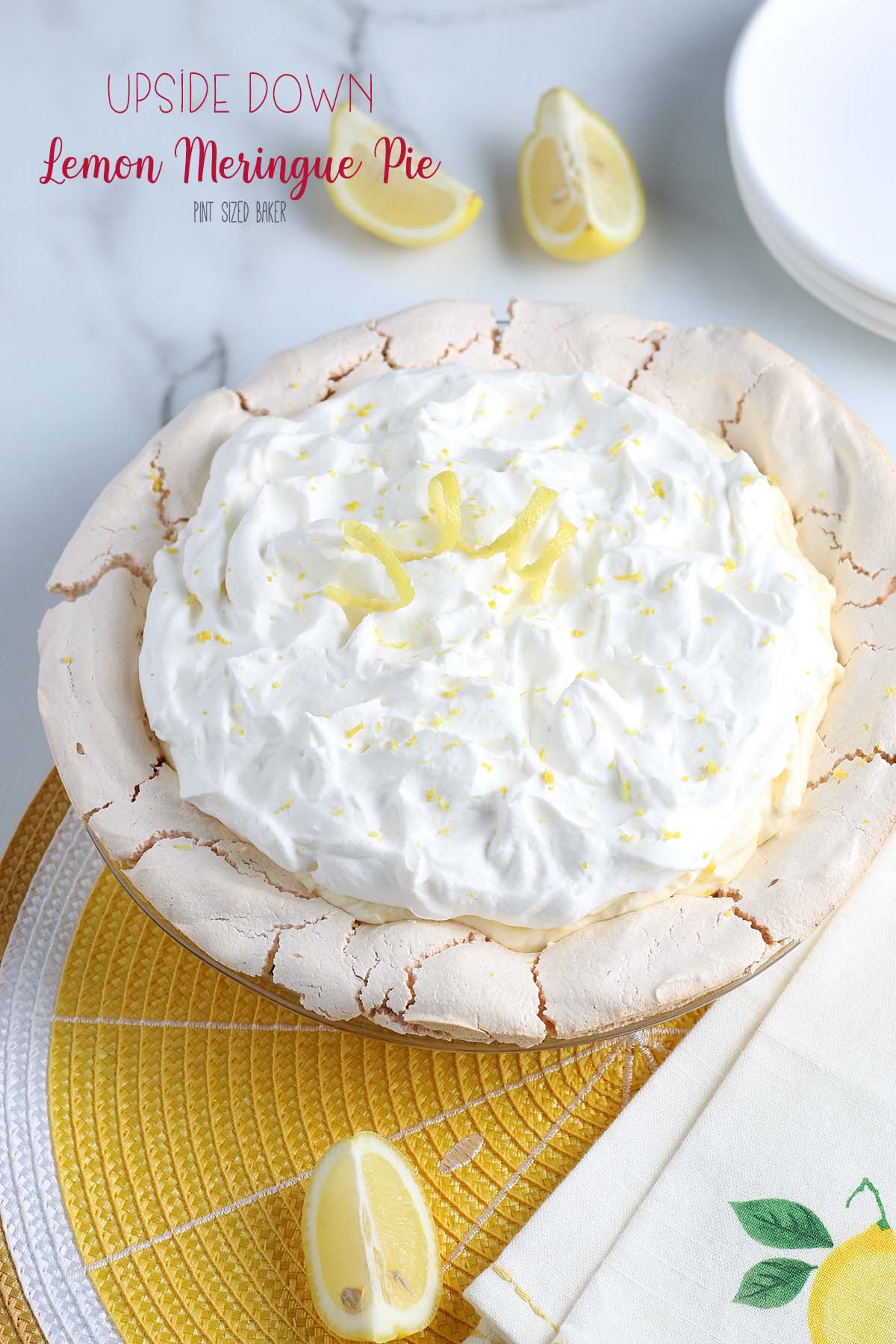 This upside down Lemon Cream Meringue Pie has the meringue on the bottom as the shell and then it's filled with sweet lemon curd and fresh whipped cream!