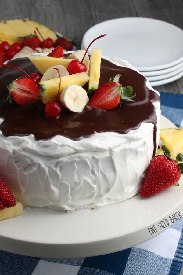 Another view that shows the finished recipe for banana split cake topped with fruit. 