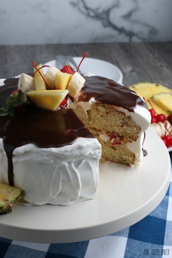 This image shows us the sliced banana split cake on a cake stand as delicious as ever. 