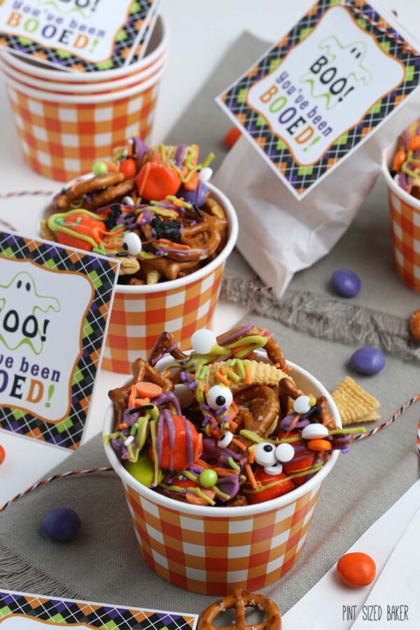 A close up photograph of the purple and green candy coated pretzel snack mix.