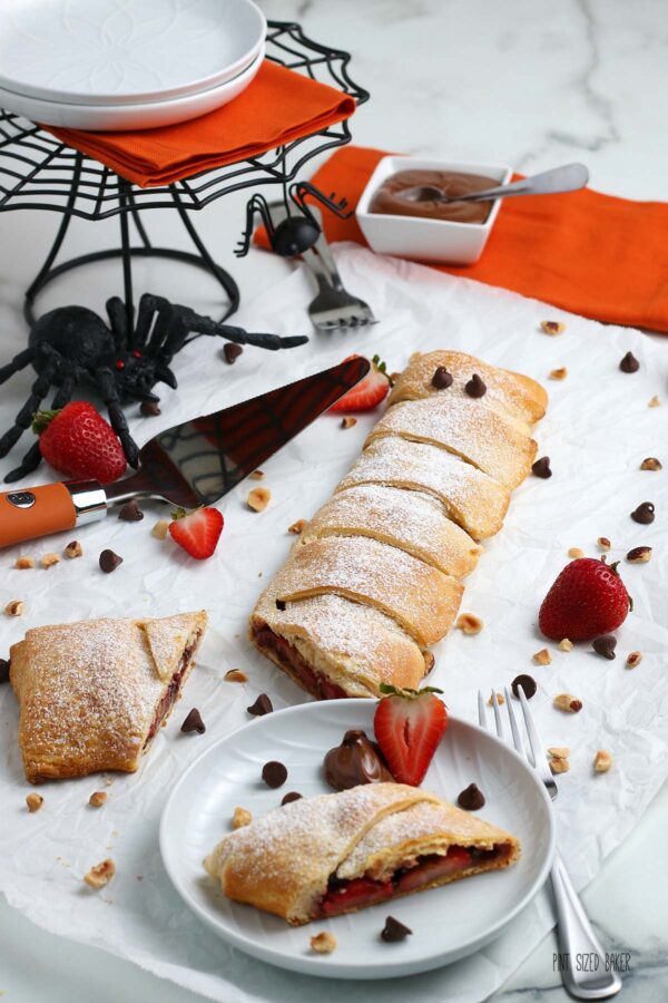 An image of the fun Halloween Mummy Pastry with spooky décor and a bowl of Nutella. 