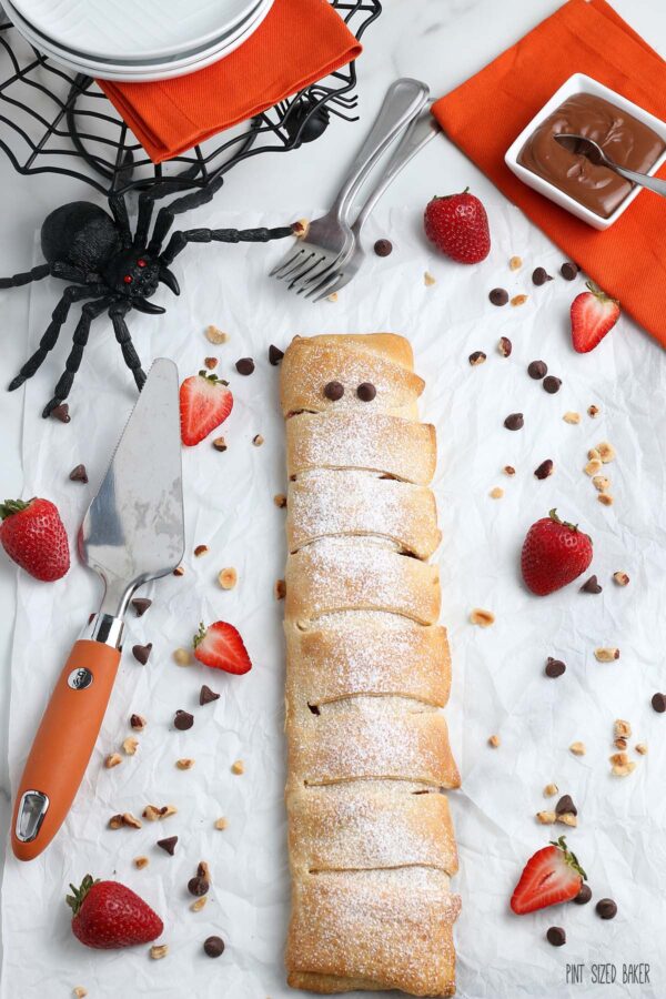 A photo of the full pastry wrap with chocolate chip eyes to make a Halloween Mummy.