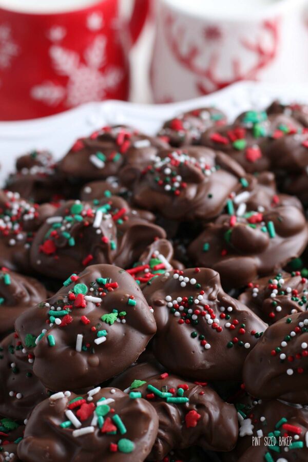 A close up photo of the red, green and white Christmas sprinkles on the chocolate and peanut candies.
