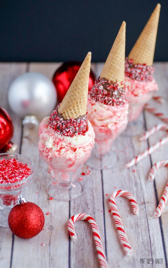 A photo of three upside-down cones in small bowls with candy canes and Christmas ornaments.  