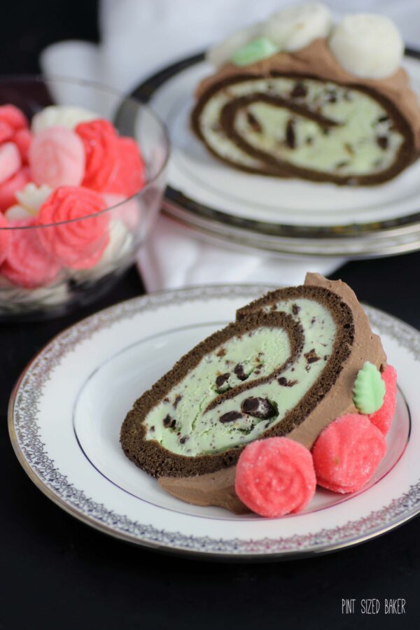 A sliced piece of cake and ice cream ready to eat.