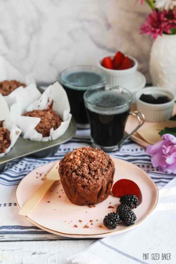 Breakfast is served with a chocoalte muffin stuffed with fresh zucchini and erved with fresh fruit and coffee.
