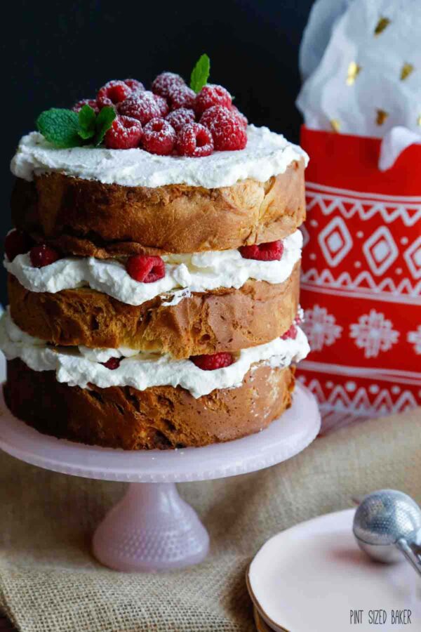 A Panettone cut into three layers and "frosted" with whipped cream and raspberries.