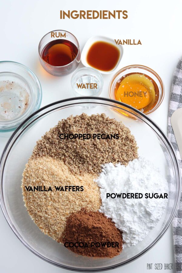 Ingredients needed to make your Rum Balls: Rum, vanilla, water, honey, pecans, powdered sugar, cocoa powder and vanilla waffers.