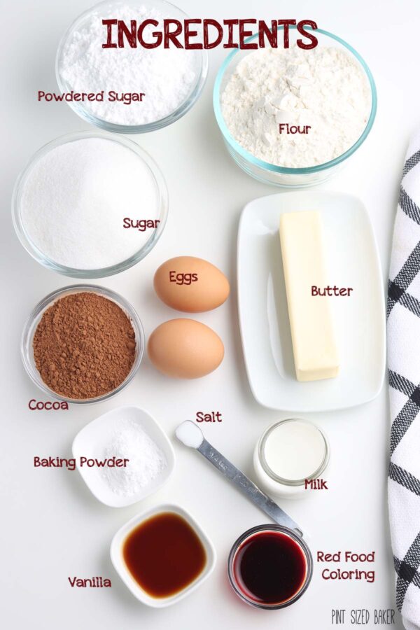 Image of the ingredients needed to make the cookies : Powdered sugar, flour, sugar, butter, eggs, cocoa, salt, baking powder, milk, vanilla, and red food coloring.